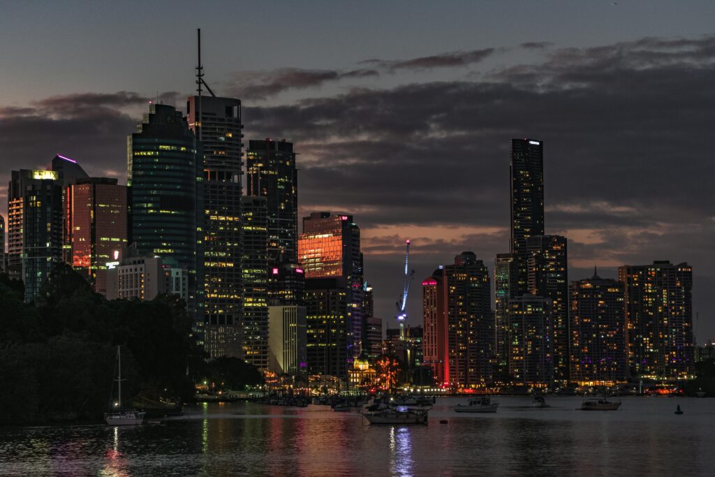 Captivating view of Brisbane's skyline at sunset, reflecting city lights on the river.